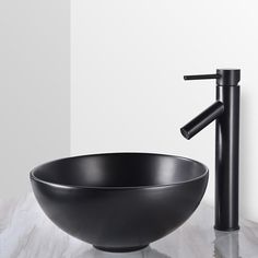 a black bowl sink sitting next to a faucet