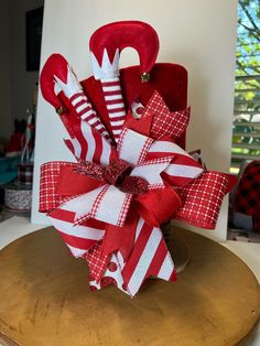 a red and white christmas decoration on top of a wooden table