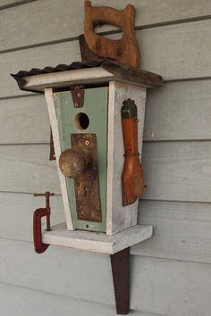 a bird house with tools attached to it