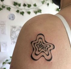 a woman's arm with a tattoo on it that has a star in the middle