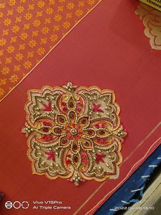 a red and gold table cloth with an intricate design on it