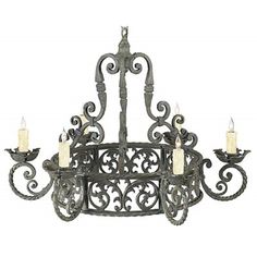 an iron chandelier with candles on it