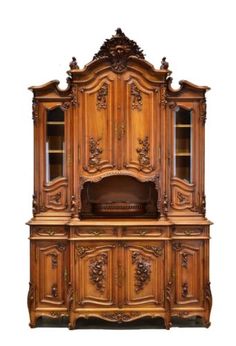 an old fashioned wooden cabinet with glass doors and carvings on the front, side view