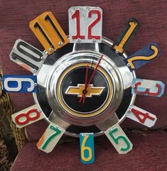 a clock made out of metal and colorful letters