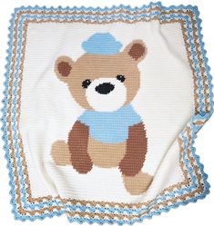 a crocheted blanket with a teddy bear on it's back and blue trimmings