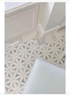 a bathroom floor with white and gray tiles