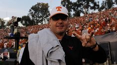 a man in a black shirt and orange hat