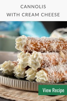 two pieces of cake sitting on top of a plate next to a bowl with whipped cream