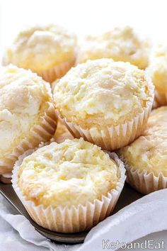 a bunch of muffins sitting on top of a metal tray next to a white napkin