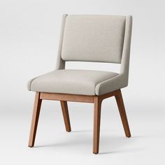 an upholstered chair with wooden legs and a light blue fabric seat, viewed from the front