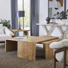 a living room with two chairs and a coffee table in front of a large window