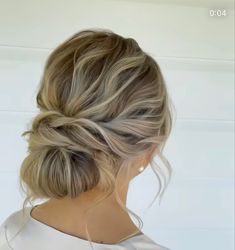 a woman with blonde hair in a low bun