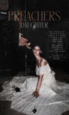 a woman sitting on the ground in front of a poster for preacher's daughter