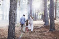 a family walking through the woods together