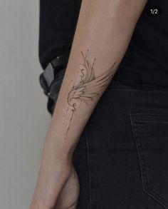 a woman's arm with a tattoo design on the left side of her arm