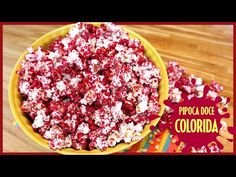 a yellow bowl filled with red and white popcorn