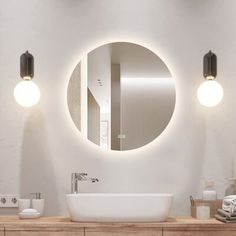 a bathroom with a sink, mirror and lights on the wall above it's counter