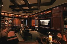 a living room filled with furniture and a flat screen tv mounted to the wall next to a fire place