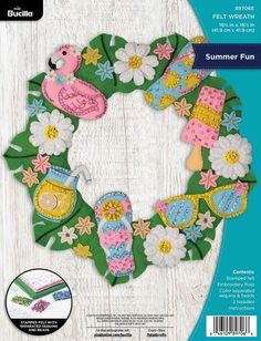 the front cover of an applique pattern for a wreath with flowers and birds on it