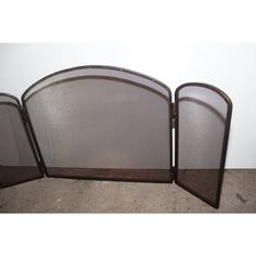 three metal fireplace screens sitting next to each other