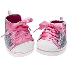 a pair of pink and white shoes with bows on the top, one shoe has sequins