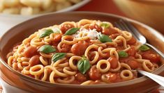 a bowl filled with pasta and sauce on top of a table