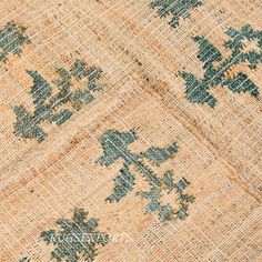 an old piece of cloth with blue and green flowers on the fabric, as seen from above