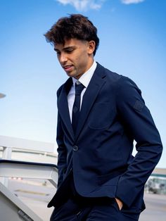 a man in a suit is standing on the stairs