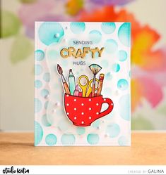 a close up of a greeting card with scissors and pencils in a cup on a table