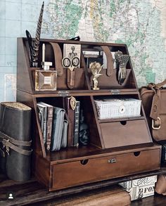 a map is on the wall next to a desk with books and other items in it