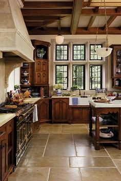 a kitchen filled with lots of wooden cabinets and counter tops