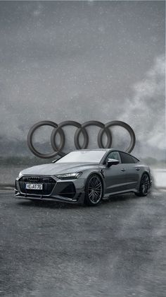 an audi car is shown in front of some rings