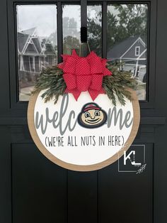 a welcome sign hanging on the front door