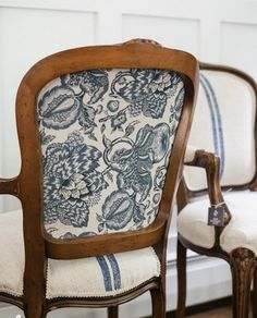 two chairs with blue and white fabric on them