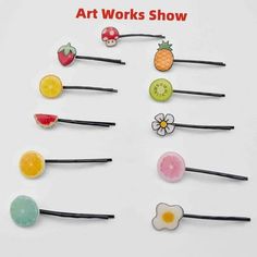 the art works show is featured with fruit and flower hair pins on black bobbys