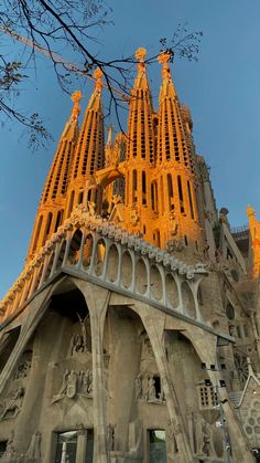 the top of a very tall building with statues on it's sides