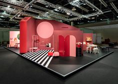 an exhibition stand with red and black accents