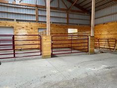 the inside of a building with wooden walls and metal railings