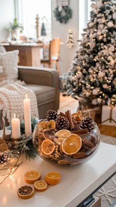 a living room decorated for christmas with oranges and cookies on the table next to it