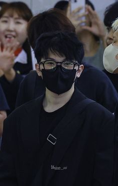 a man wearing a face mask and black jacket