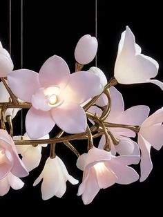 a chandelier with flowers hanging from it's sides and lights in the middle