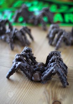 chocolate spider decorations sitting on top of a wooden table