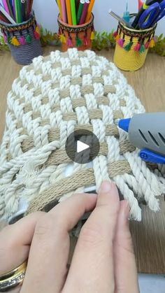 someone is working on a crocheted rug with scissors