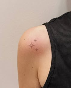 a woman with a small star tattoo on her shoulder