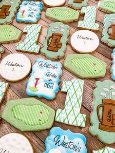 decorated cookies for a golf themed baby's shower are on a table with other decorations