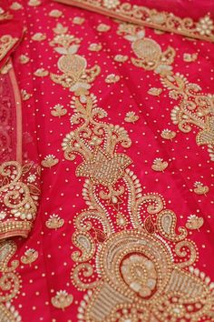 red and gold brocaded fabric with intricate designs on the top, along with golden trimmings