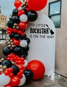 the balloon arch is decorated with black, white and red balloons