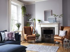 a living room filled with furniture and a fire place