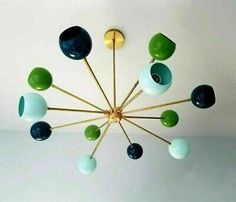 a chandelier with green and blue glass balls hanging from it's center