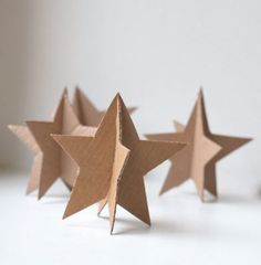 three brown paper stars sitting next to each other